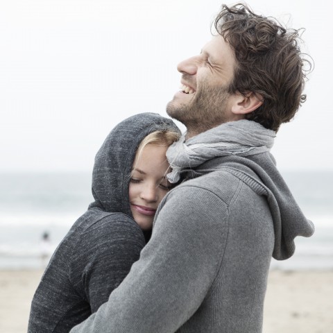 A Couple Embraces on a Beach