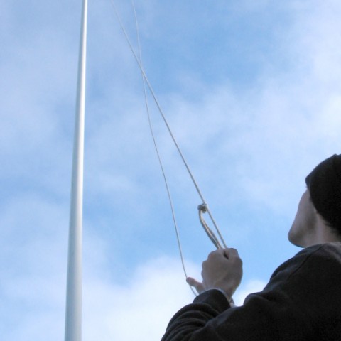 Man Hoisting a Flag