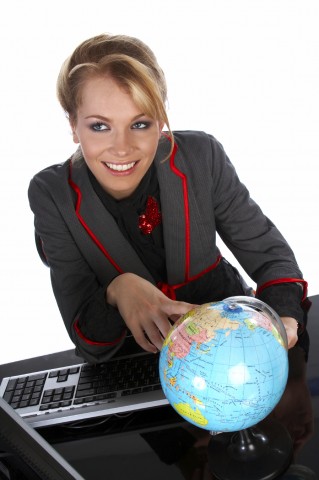 A Woman Pointing Her Finger to Somewhere on a Globe