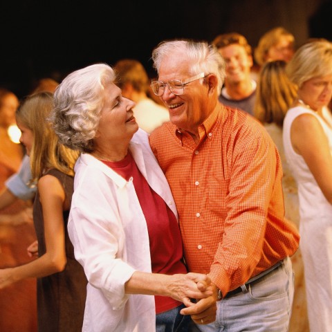 An Old Couple Dancing Together at a Party