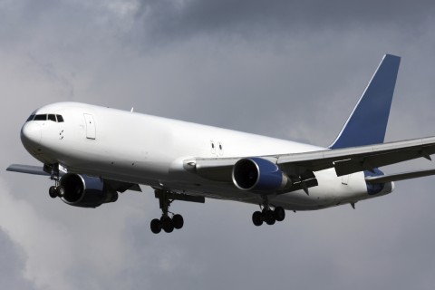 Plane Flying Past Clouds