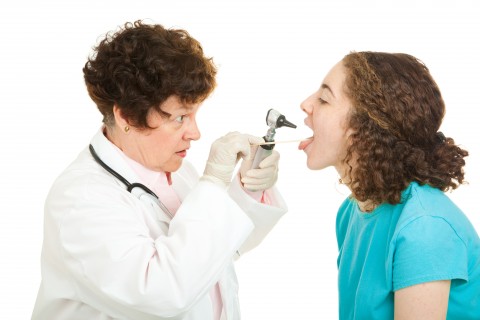 A Woman Getting Her Mouth Checked by a Doctor