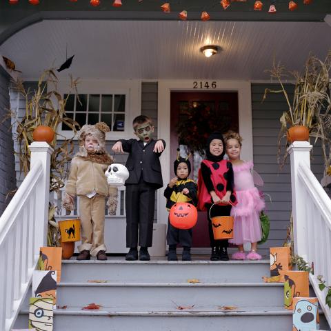 A Group of Children Dressed in Costumes and Trick-or-treating