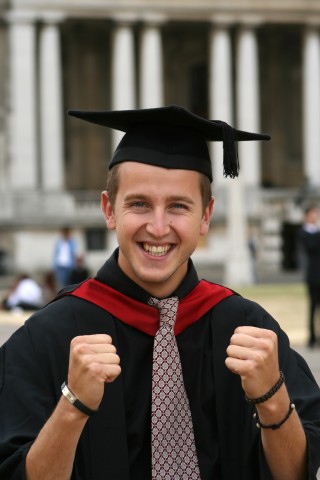 A Man Celebrating while Wearing a Graduation Cap