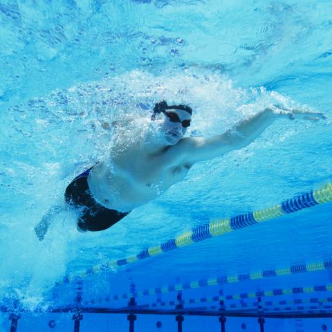 Man Swimming in Pool