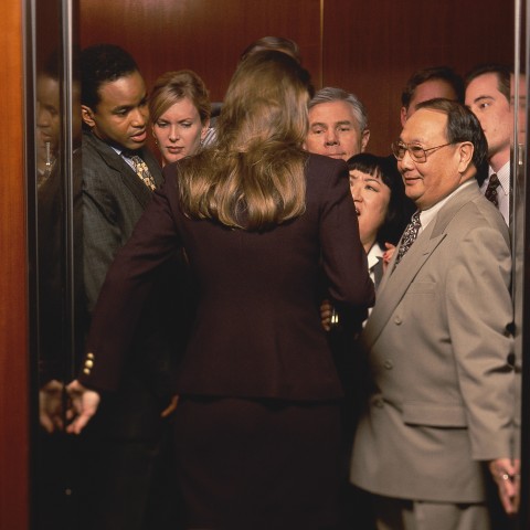 A Woman Entering a Crowded Elevator