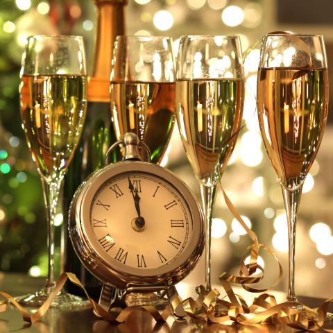 Four Glasses of Champagne behind a Clock
