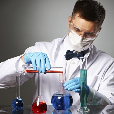 A Scientist Experimenting with Different Liquids in a Lab