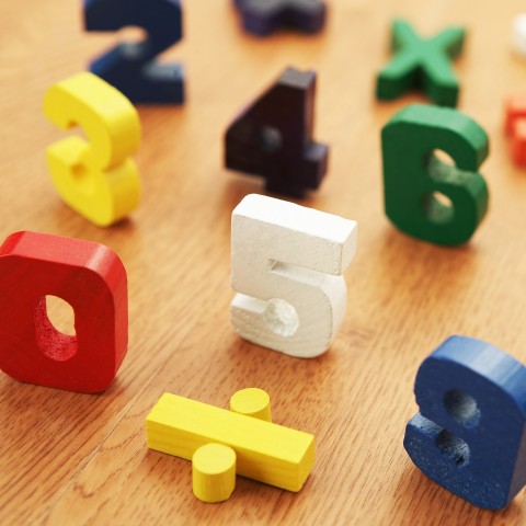 Colorful Wooden Blocks Shaped Like Numbers and Mathematical Signs