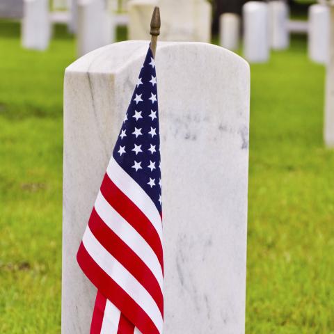 A Small American Flag in Front of a Veteran’s Tombstone