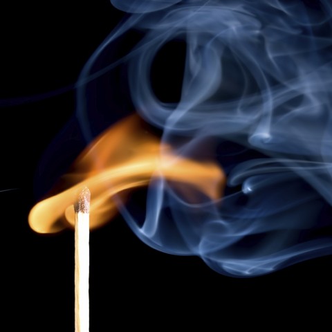 A Lit Match with Flame and Smoke