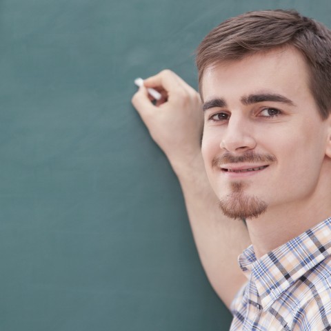 Man Writing on Blackboard