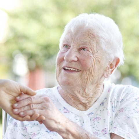 An Elderly Man Holding Hands with a Younger Person