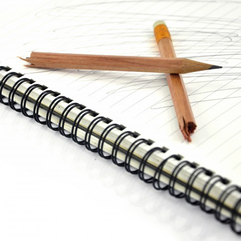 Broken Pencil on Notebook