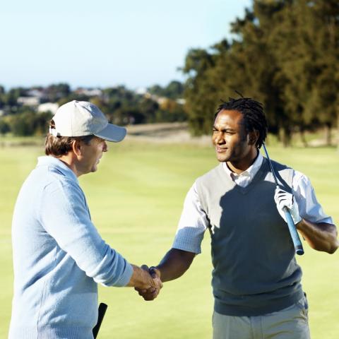 Men on Golf Course Shaking Hands
