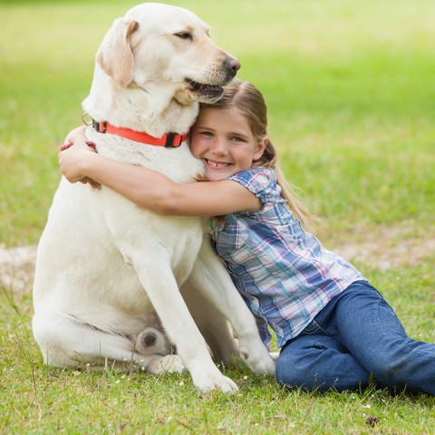 A Girl Hugging a Dog
