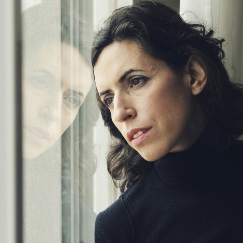Depressed Woman Looking Out Window