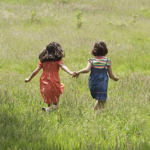 Two Girls Running in Field