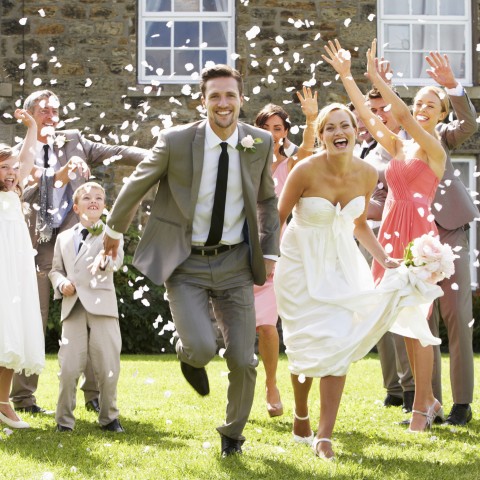 Bride and Groom While People Throw Petals