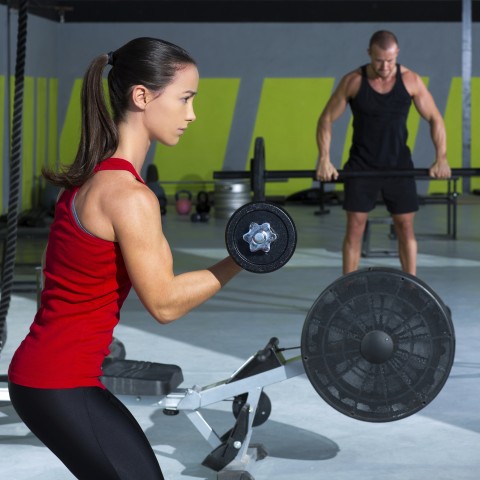 Woman and Man Weightlifting at the Gym