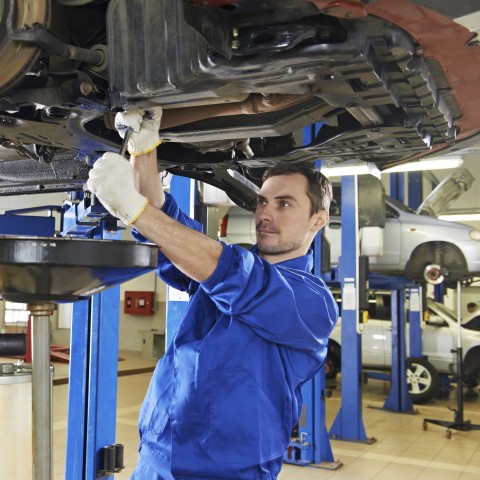 Car Mechanic, Working Underneath a Car