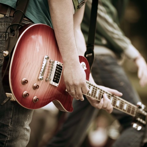 Close-up of Someone Playing a Guitar at a Concert