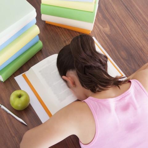 A Woman Is Tired from Reading a Textbook