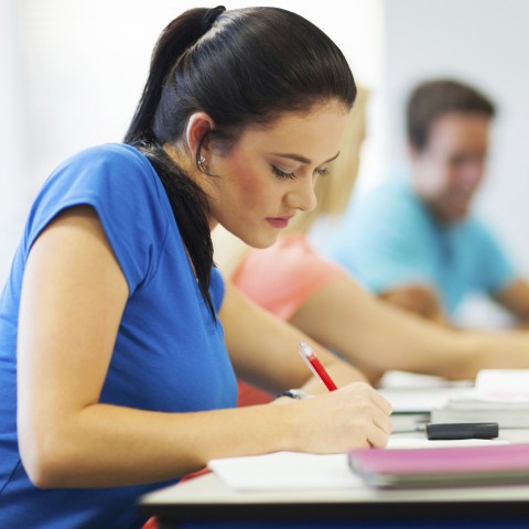 Woman Taking Notes in Class