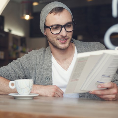 Man Reading in Cafe