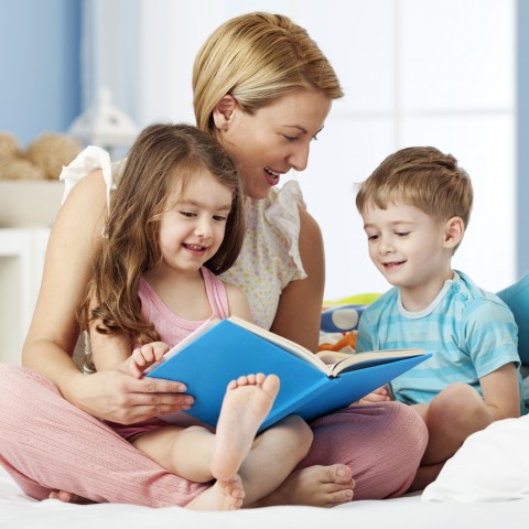 A Mother and Two Children Enjoying a Story