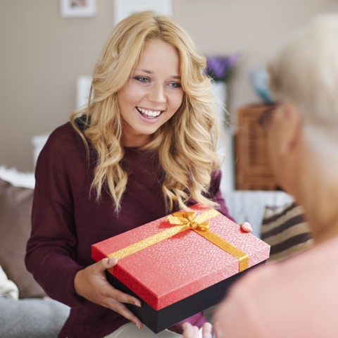 A Blonde Woman Offering a Present