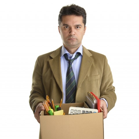A Man Carrying a Box of His Office Things