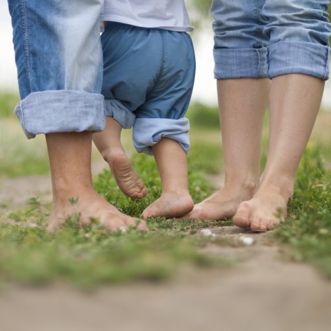 a picture of bare feet of three people