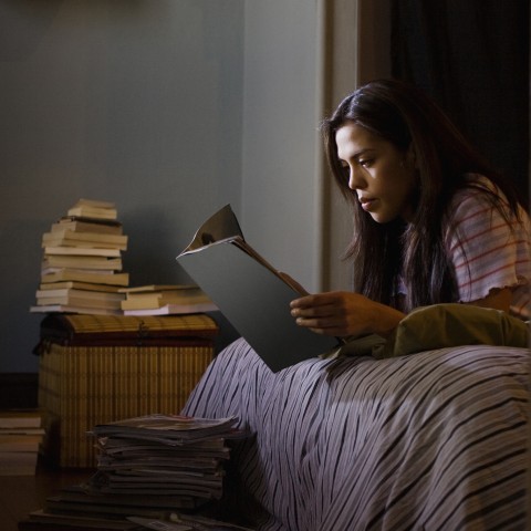 Woman Reading a Book at Night