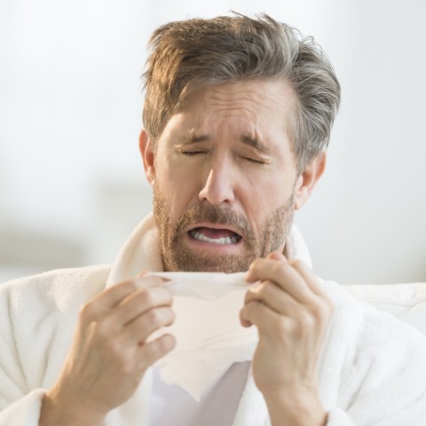 A Man Sneezing