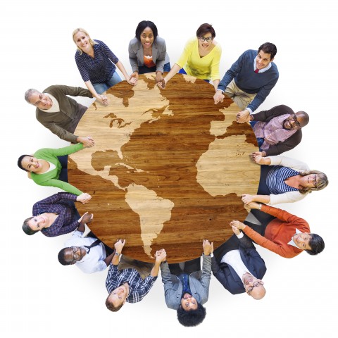 People Surrounding a Round Table that Looks Like a Globe