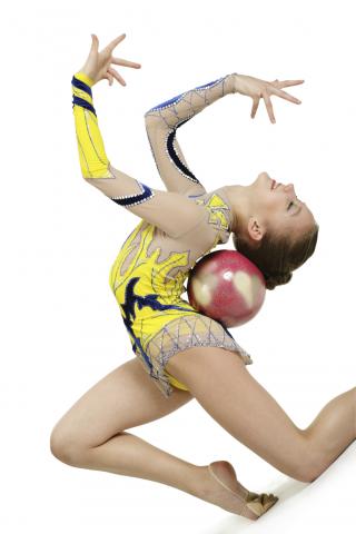Woman Balancing a Ball in the Curve of Her Back
