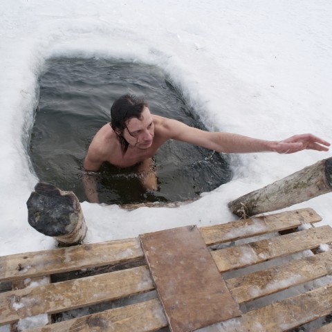Man Swimming in Ice-covered Water