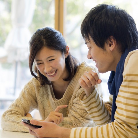 A Man Is Showing His Phone to a Woman and Having a Conversation