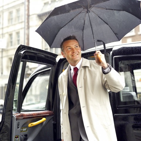 Man Getting Out of Car with Ubrella