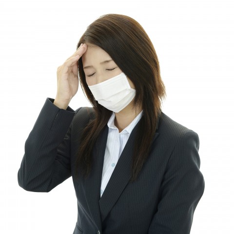 A Lady Wearing a Mask Is Feeling Unwell