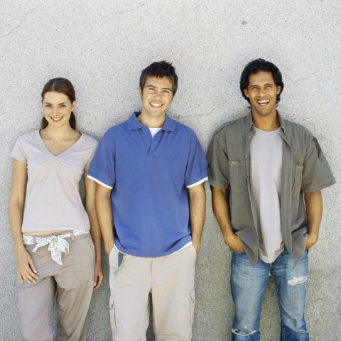 People Standing against a Wall with Hands in Their Pockets and at Their Sides