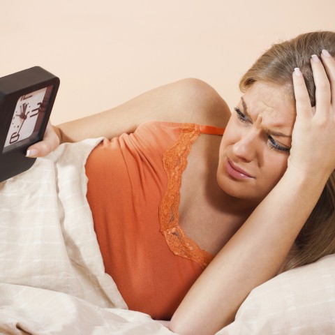 Woman Looking at a Clock