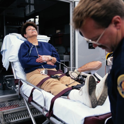 A Woman Being Boarded onto an Ambulance