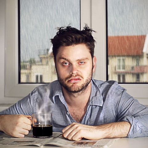 A Tired Man Drinking Coffee