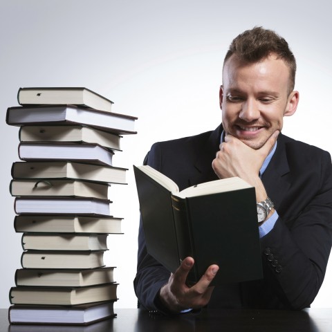 Man Reading Lots of Books