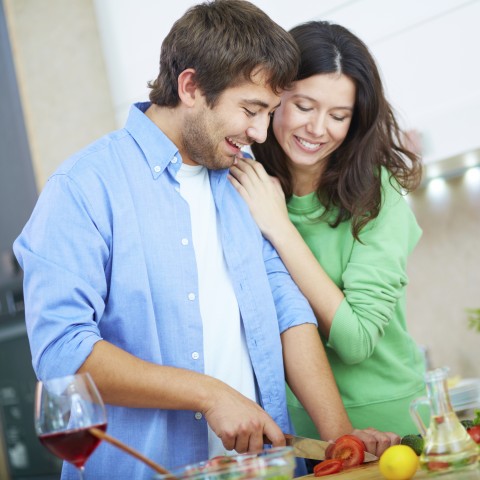 Couple Cooking and Smiling