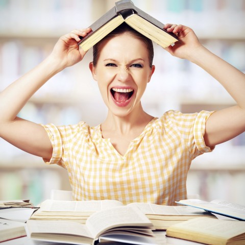 A Woman Studying and Laughing