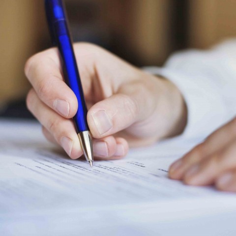 man writing in a journal