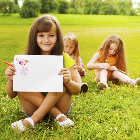 A Girl Happily Shows Her Drawing.